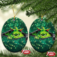 Set of green oval cat Christmas ornaments with neon cartoon cat face and zipper graphic.