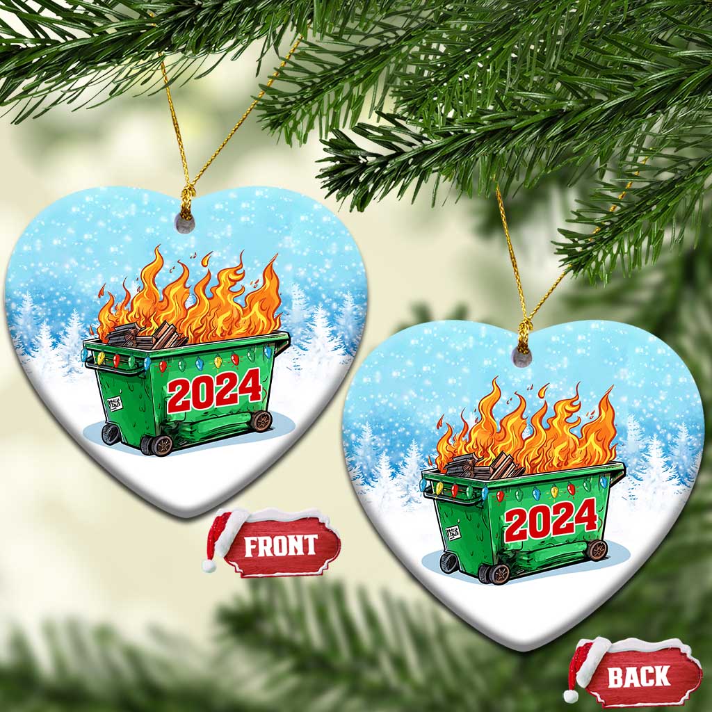 Heart-shaped blue ornament with green dumpster fire and red 2024 on snowy background.