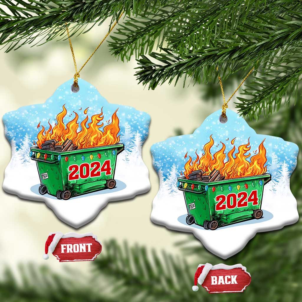 Pair of heart-shaped blue ornaments with green dumpster fire and red 2024 on snowy background.
