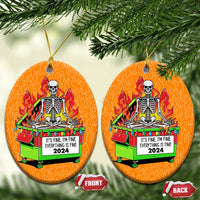 Two orange circle Christmas ornaments with skeleton-in-flames dumpster design and front/back tags