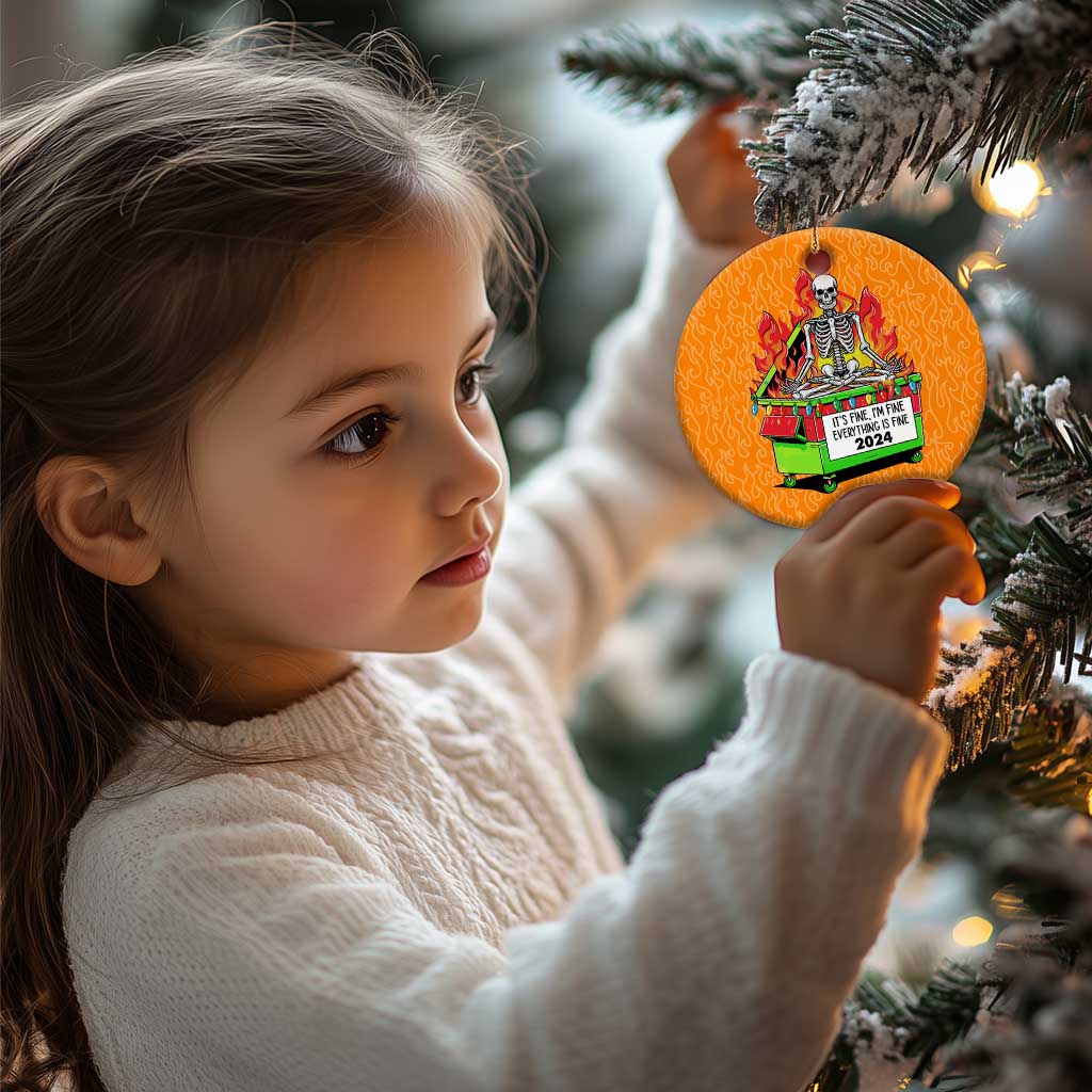 Orange circle Christmas ornament held by a child, skeleton-in-flames dumpster design