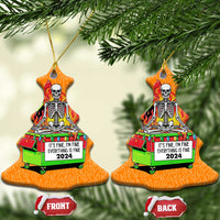 Pair of orange bell-shaped Christmas ornaments with skeleton-in-flames dumpster artwork