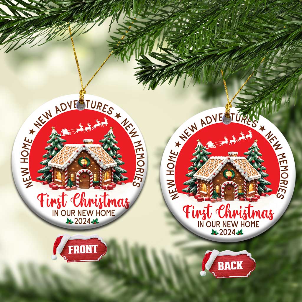 Two red round Christmas ornaments on branches, featuring a decorated house and “First Christmas 2024”.