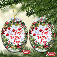 Oval Christmas ornament with “Best Teacher Ever” text, decorated with pine and red berries