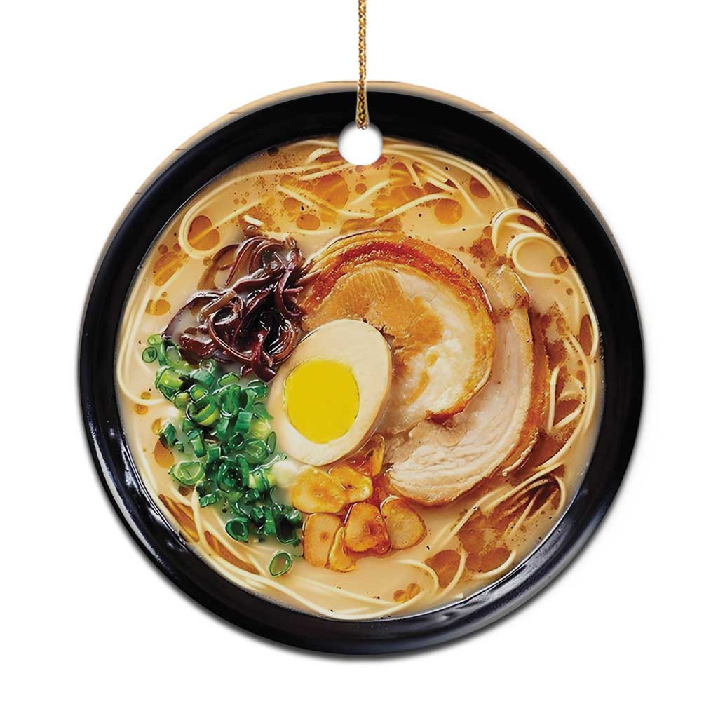 Round ramen bowl Christmas ornament with gold hanging loop and printed egg, pork, noodles.