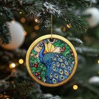 Gold round peacock bird ornament hanging on a Christmas tree branch
