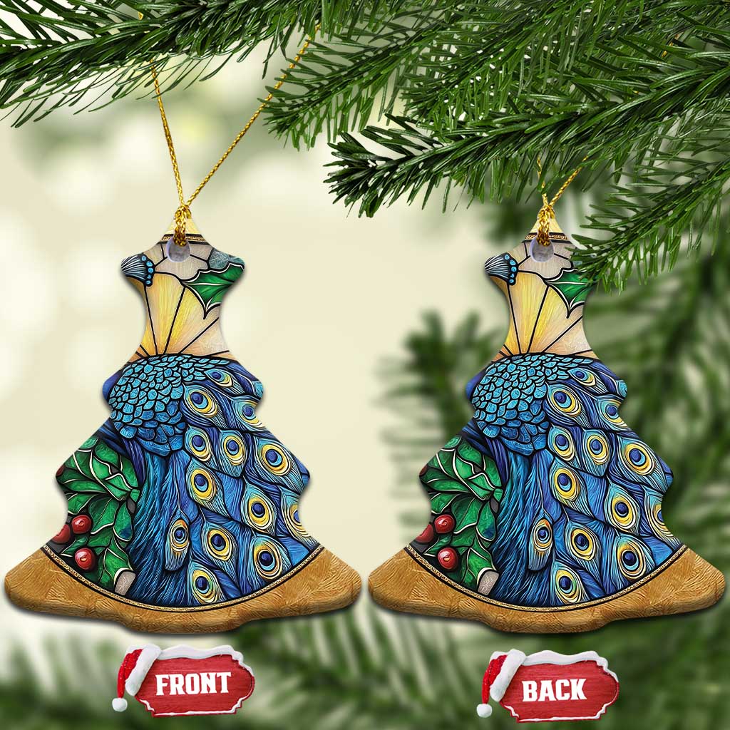 Two gold bell-shaped peacock bird ornaments with blue feather detail and green leaves