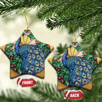Two gold star-shaped peacock bird ornaments with blue feathers and red berry accents