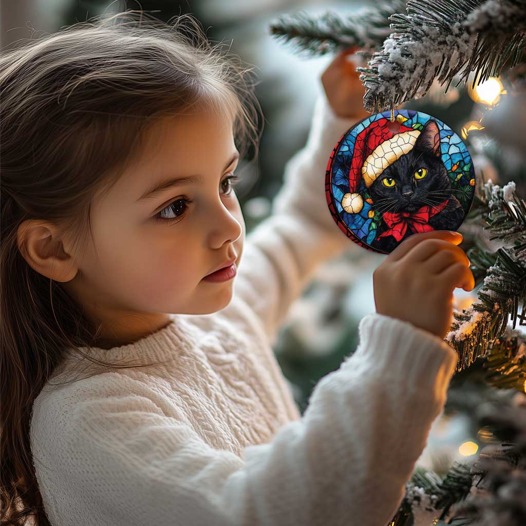 Round Santa black cat ornament with red bow on stained-glass pattern, gold hanging loop
