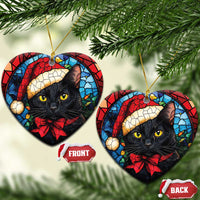 Heart-shaped Christmas ornaments showing a black cat in Santa hat with red bow