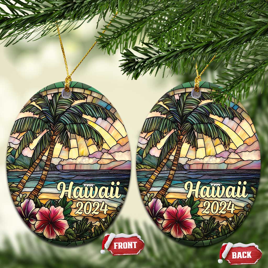 Two Hawaii 2024 circle ornaments hanging from gold cords with palm trees and hibiscus