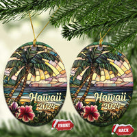 Two Hawaii 2024 circle ornaments hanging from gold cords with palm trees and hibiscus