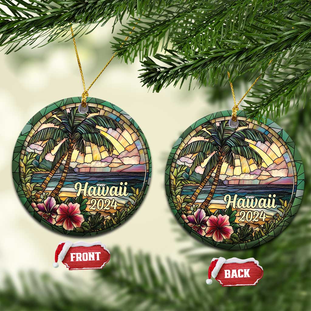 Two Hawaii 2024 circle ornaments hanging from gold cords, palm trees and ocean scene