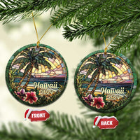 Two Hawaii 2024 circle ornaments hanging from gold cords, palm trees and ocean scene