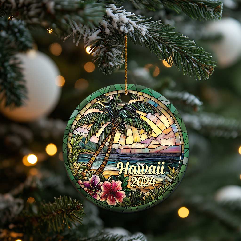 Hawaii 2024 circle ornament hanging from a gold cord, palm trees and ocean waves