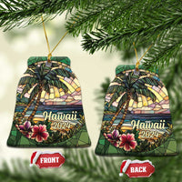 Two Hawaii 2024 bell-shaped ornaments with palm trees, ocean waves, and hibiscus