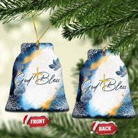 Blue and white bell-shaped Christmas ornament with gold cross and God Bless text