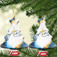 Two blue bell-shaped ornaments with gold cross and God Bless lettering, front/back visible