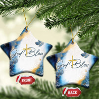 Blue and white star-shaped ornament set with gold cross and God Bless text