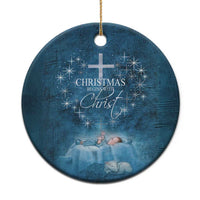 Blue round ornament with cross and 'Christmas begins with Christ' lettering