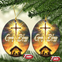 Set of two oval nativity ornaments with glowing cross and “God Bless,” with manger scene