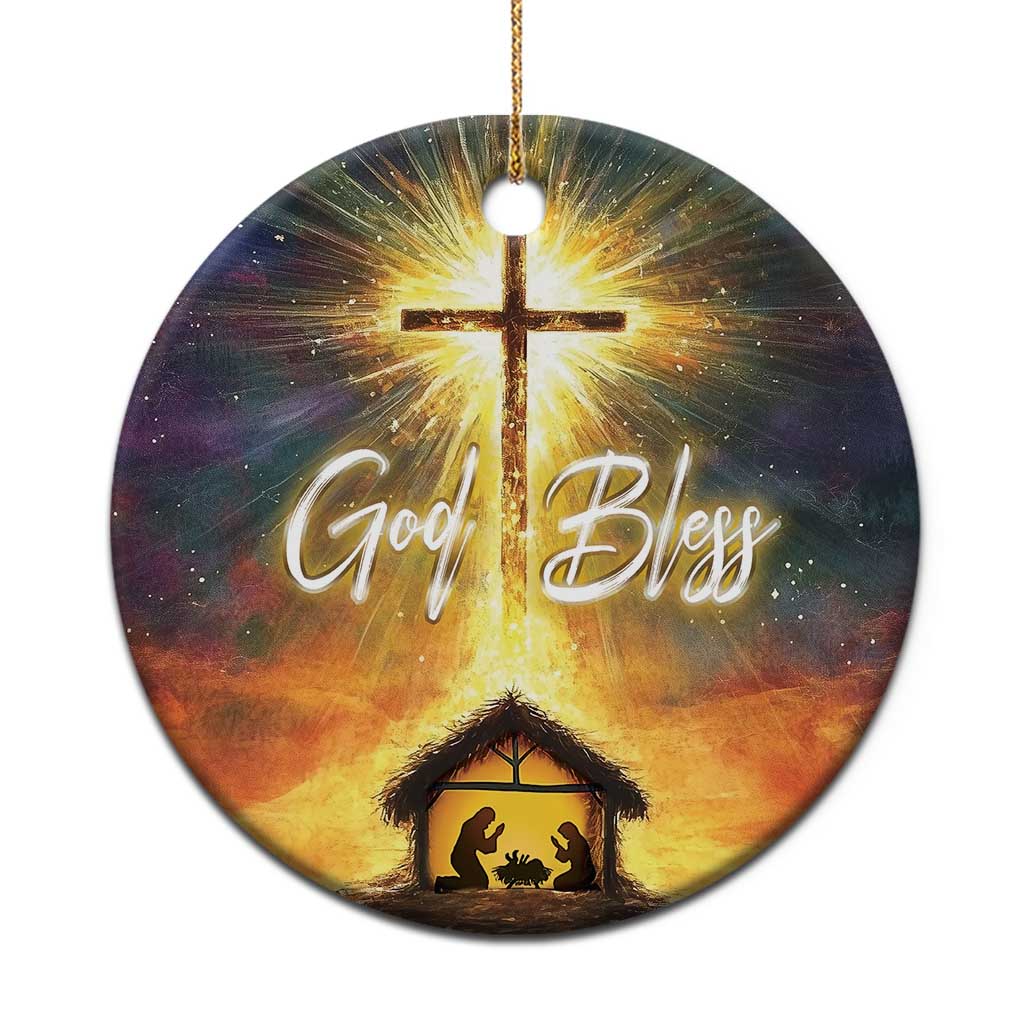 Round Christian nativity ornament with glowing cross, “God Bless” text, and manger scene