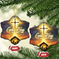 Set of two star nativity ornaments with glowing cross, “God Bless,” and manger scene