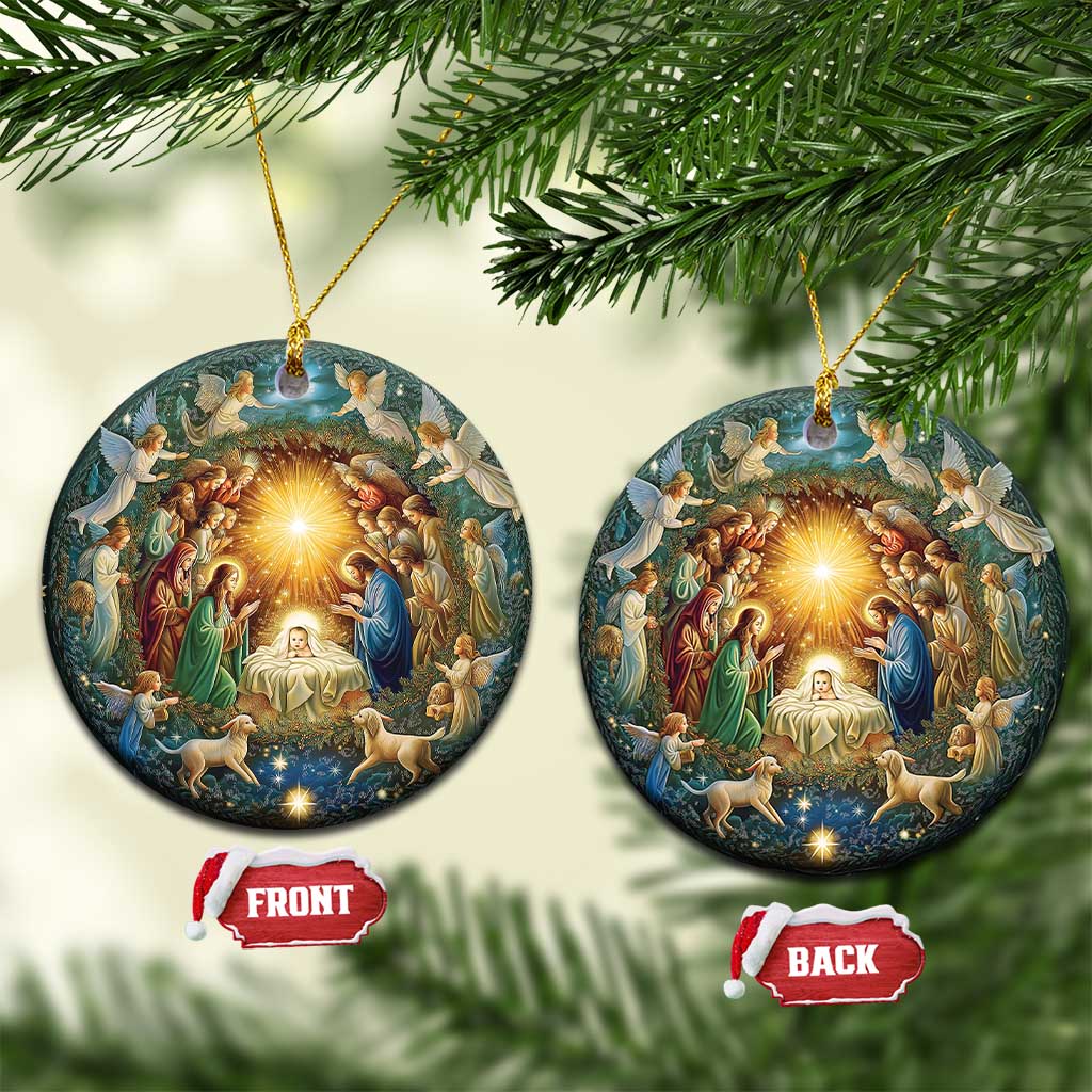 Pair of round nativity ornaments with gold hanging cords and illuminated manger scene