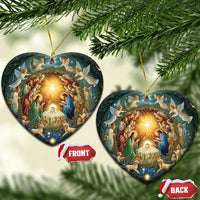 Heart-shaped nativity ornaments with gold hanging cords and glowing manger scene