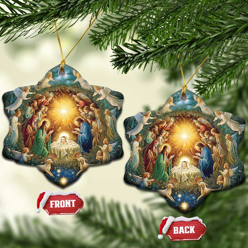 Set of heart nativity ornaments with gold cords, featuring a glowing manger artwork