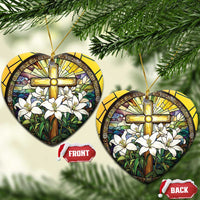 Heart-shaped stained-glass style ornament with gold cross and white flowers