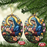Pair of oval Christian Christmas ornaments featuring Mary in blue robe among colorful flowers, gold loops