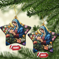 Two star-shaped Christian Christmas ornaments with Mary in blue robe holding flowers, gold loops