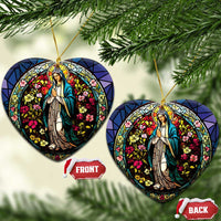 Two heart-shaped Mary stained-glass ornaments with gold hooks and colorful floral details