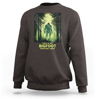 Dark chocolate brown sweatshirt with front Bigfoot hunting graphic and crew neck cuffs