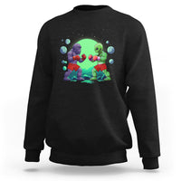 Black crewneck sweatshirt with boxing Bigfoot vs alien graphic on the front.