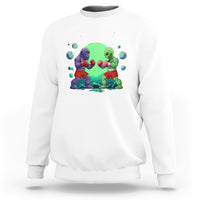 White crewneck sweatshirt with boxing Bigfoot vs alien graphic on the front.