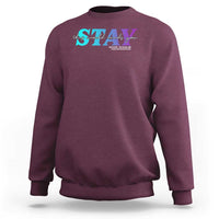 Maroon crewneck sweatshirt with colorful call or text 988 support graphic on chest
