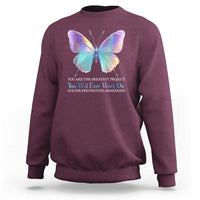 Maroon crewneck sweatshirt with rainbow butterfly and inspirational suicide prevention text