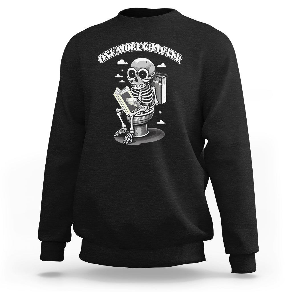 Black sweatshirt with skeleton holding a book graphic on the chest.