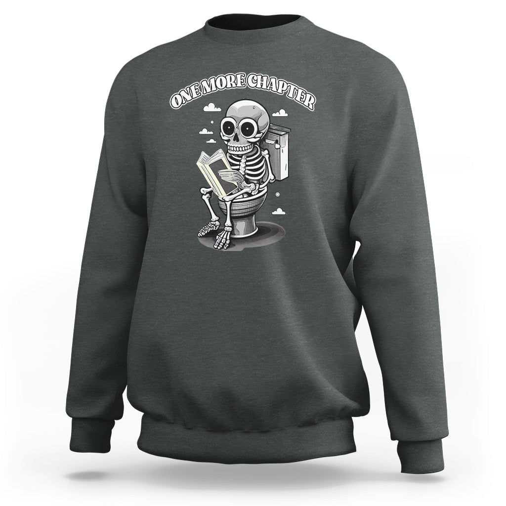 Dark gray sweatshirt with skeleton holding a book graphic on the chest.