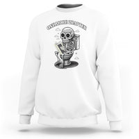 White sweatshirt with skeleton holding a book graphic on the chest.
