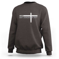 Dark chocolate sweatshirt with cross graphic and text design at the chest