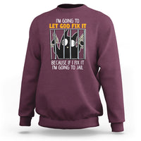 Maroon crewneck sweatshirt with front text graphic: “LET GOD FIX IT”