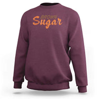 Men's maroon crewneck sweatshirt with orange 'BROWN Sugar' logo on chest