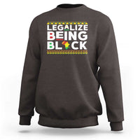 Dark brown sweatshirt with “Legalize Being Black” graphic across the chest.