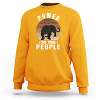 Gold sweatshirt with “POWER TO THE PEOPLE” panther graphic on front