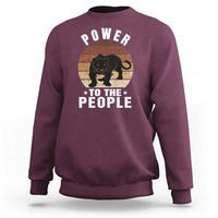 Maroon sweatshirt with “POWER TO THE PEOPLE” panther graphic on front