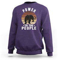Purple sweatshirt with “POWER TO THE PEOPLE” panther graphic on front