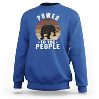 Royal blue sweatshirt with “POWER TO THE PEOPLE” panther graphic on front
